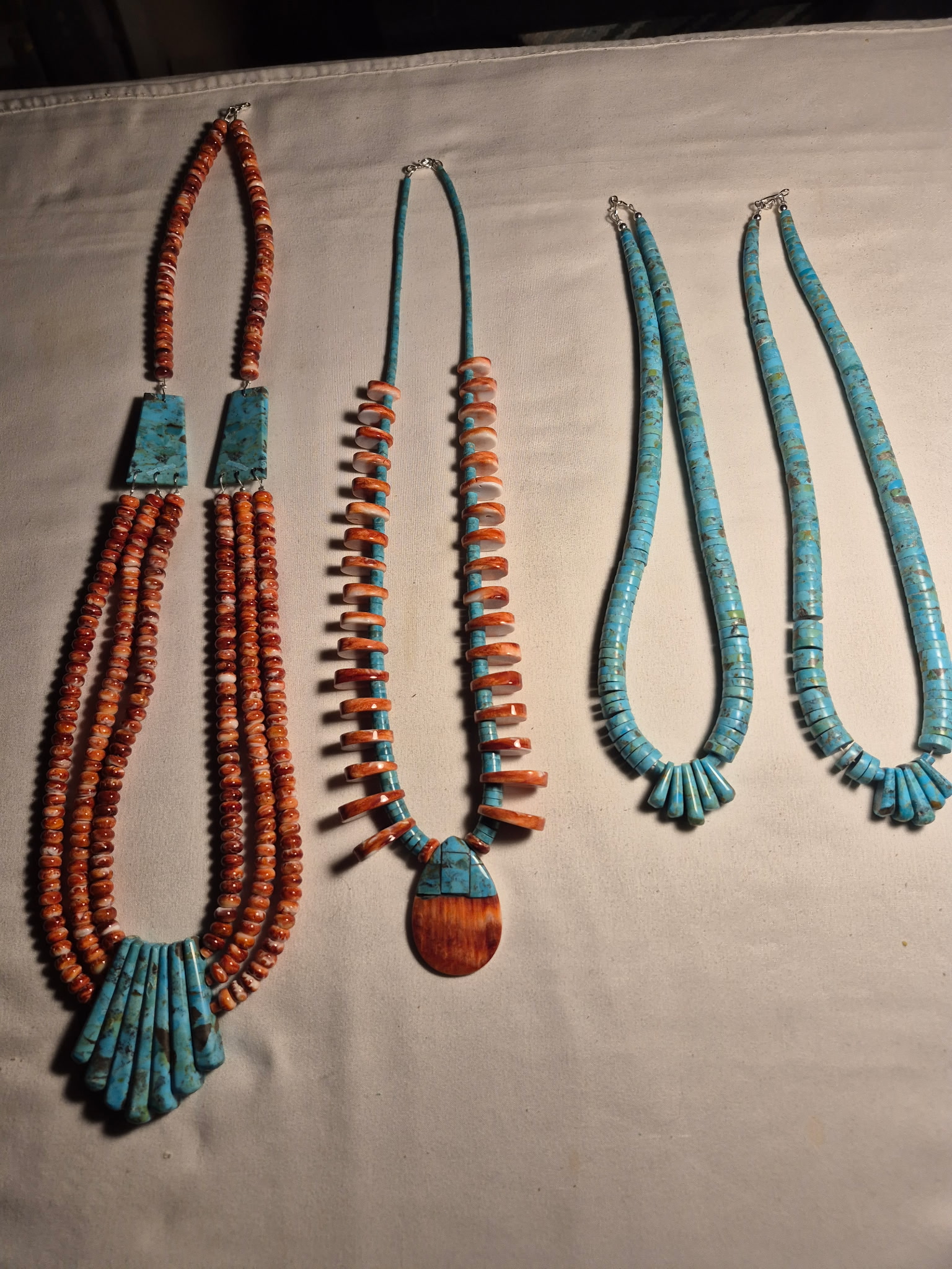Three handcrafted necklaces with turquoise and orange shell