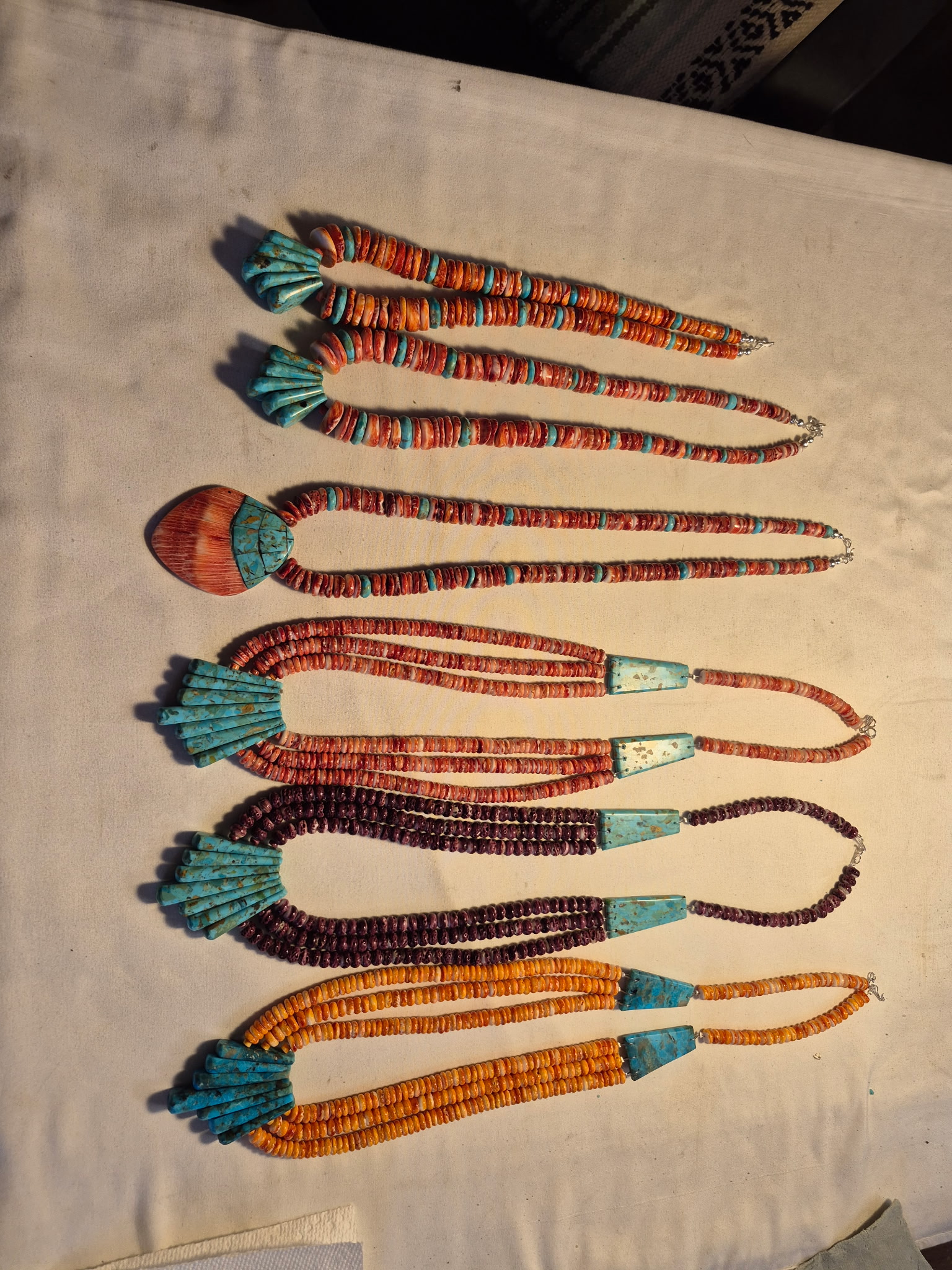 Four necklaces with shell pendants